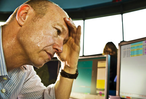 photolibrary_rm_photo_of_stressed_man_sweating_at_desk