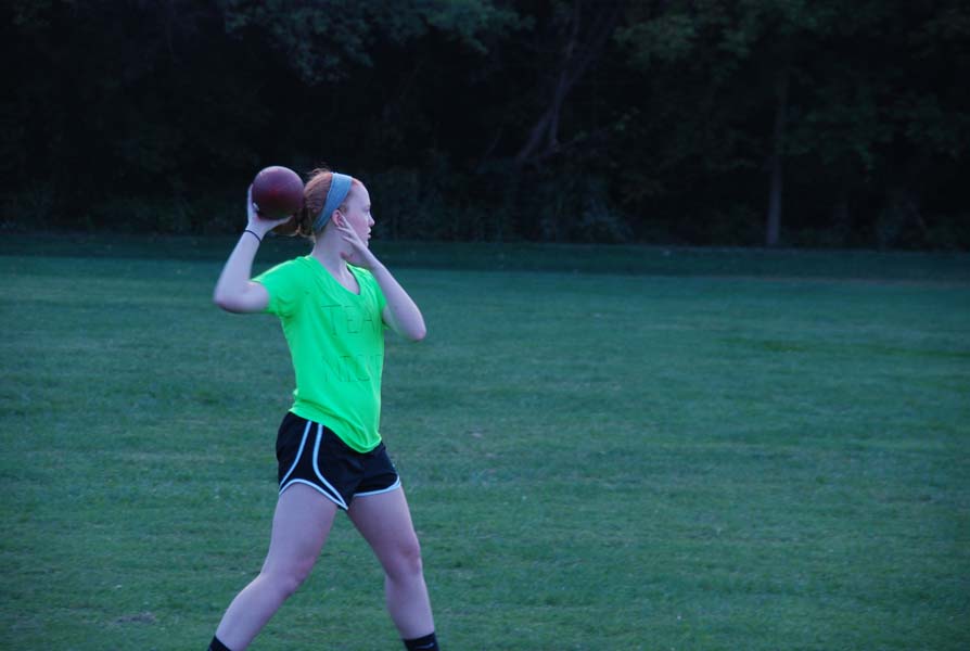 Before the game, senior Julia Stillwell warms up her arm. Stillwell made a large impact on the game catching passes.