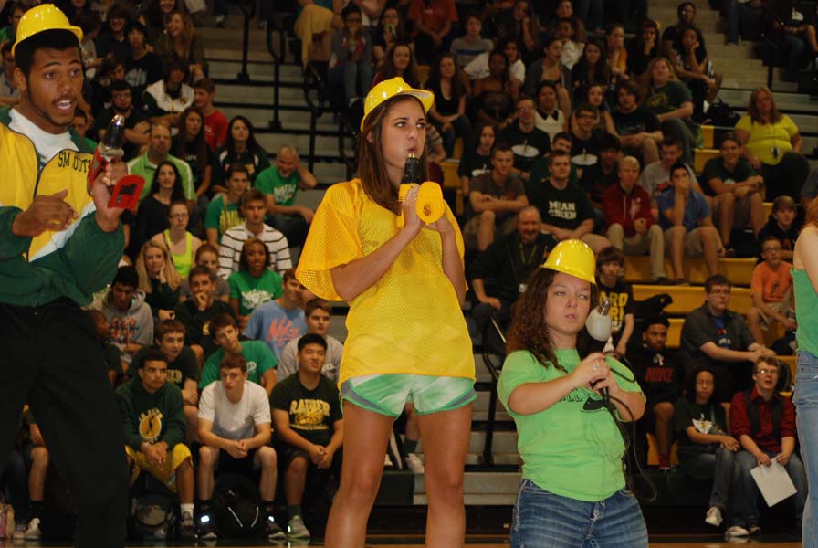 With drills in their hands, senior pep club exects Rasheed Brady, Jenna Folies, and Kelly OConnor perform a skit at the homecoming assembly. This years assembly was held on Friday, October 4th.