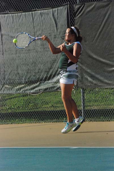 On her toes, junior Emily Anderson hits and returns the ball back to her opponent. Anderson was one of the top varisty players on this years tennis team.