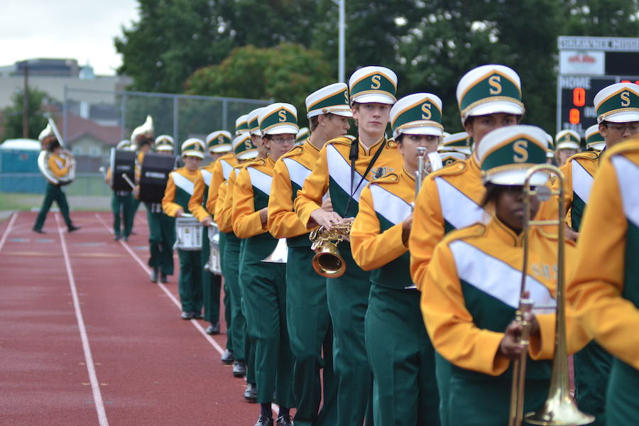 The Rompin Stompin Raider Band marches across the track during the South/North football game.