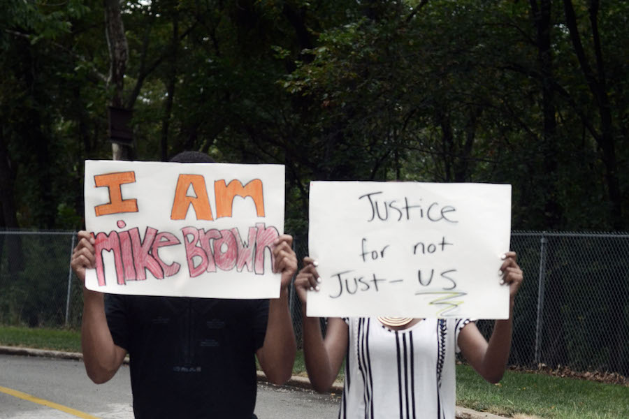 From left: junior Remy Gordon and senior Corida Cooperwood stand in solidarity with Ferguson, protesting the death of Michael Brown. 