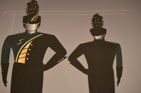 This is the first design, with a gold arch across the chest and golden buttons with a black left shoulder and green on the right shoulder.