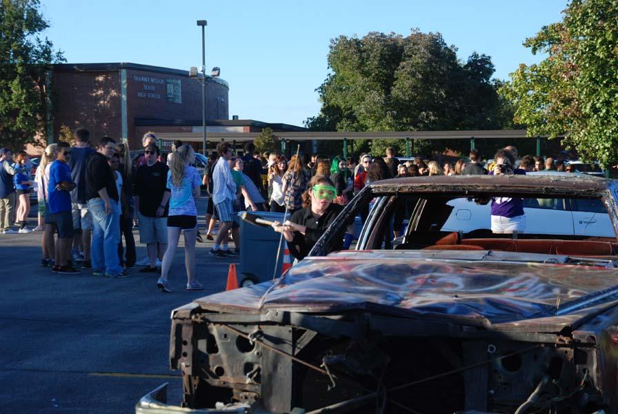 Smashing the car hard, sophomore Lydia Thorn participates in the annul car smashing. Every year Ksms puts on the Bonfire with a car smashing, a huge bonfire, and great food.