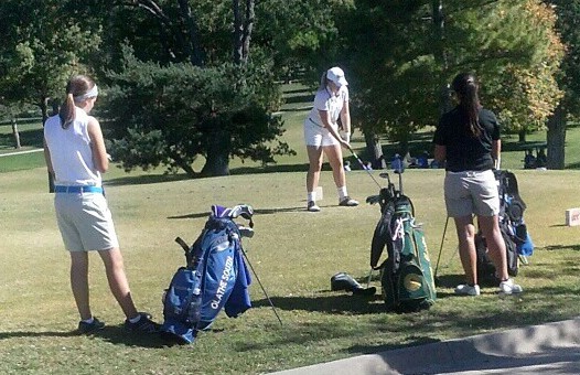 About to swing senior Rachel Larberg lines her driver with the flag. Larberg and two other girls made it to state. 