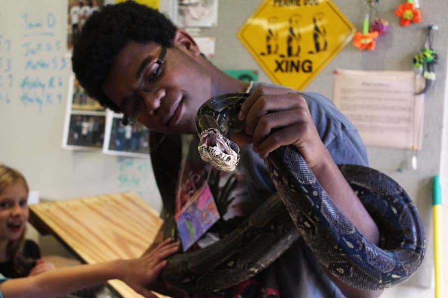 Holding the snake, junior Tyree Hamilton shows kids during the Environmental Education tour. The tours took place during the spring and fall.