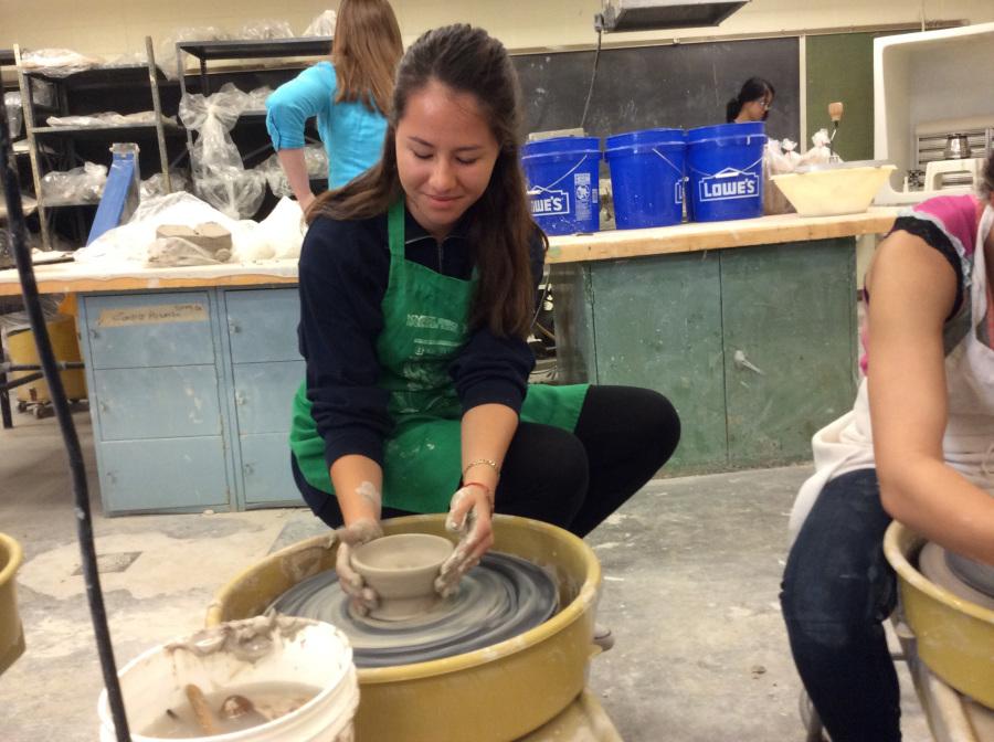 Frida Fregozo works to create a bowl on the wheel