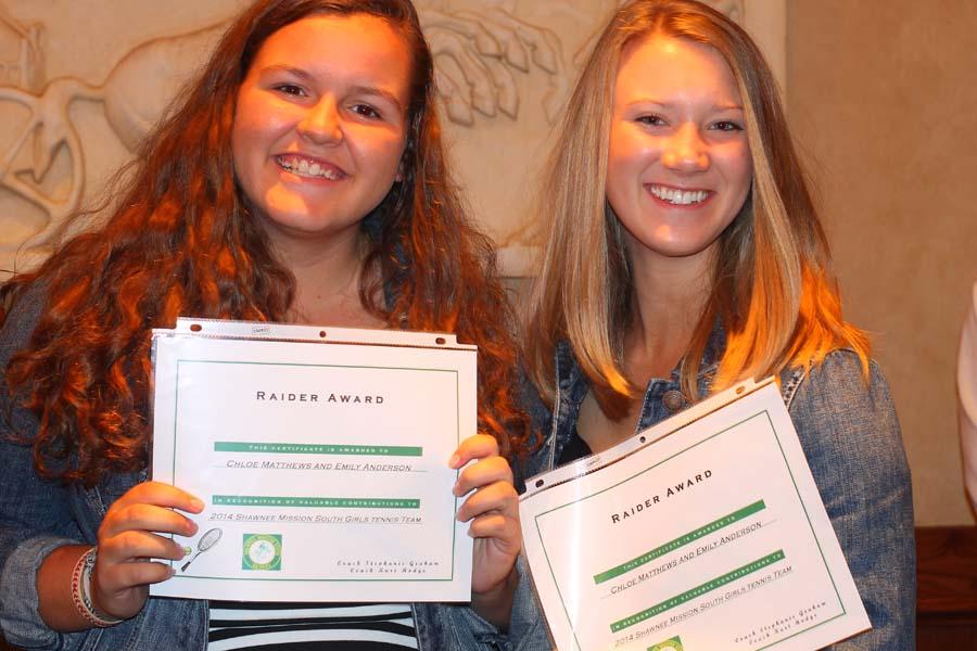 Showing their certificates for valuable contribution, seniors Emily Anderson and Chloe Mathews pose for the camera at this years tennis banquet.