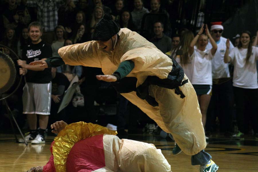 Going in for the finishing move, history teacher Brett McFall jumps on government teacher Tony Budhetti during the sumo fight. The sumo fight took place during the winter assembly.