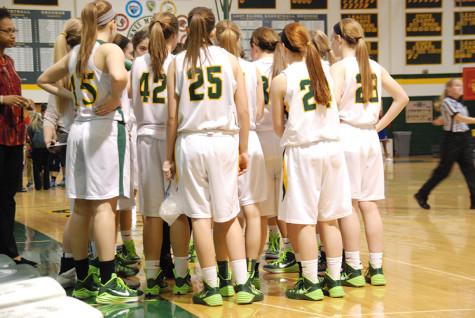 Varsity team huddles up. Head coach Kelsey Hill pumped up her team before the game on February 24.