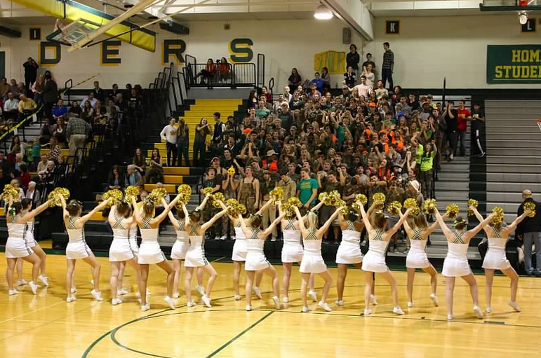 Cheerleaders dance to Hey Baby at home basketball game.