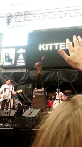 In the middle of the set, the lead singer of Kitten stands on an amplifier. 