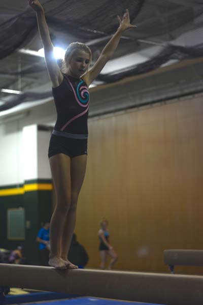 Freshman Bergan Cooper, trys out her new beam routine. She has not placed yet but that wont stop her.