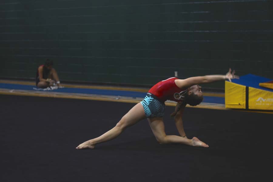 Freshman Hannah Carter, shows her coach her floor routine. At the first meet she broke her ankle in the beam category.