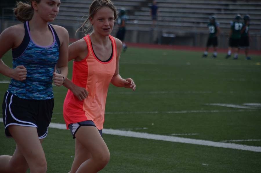 Sophomore Madison Goerz and Freshman Sofie Erickson run together for costs country practice. 