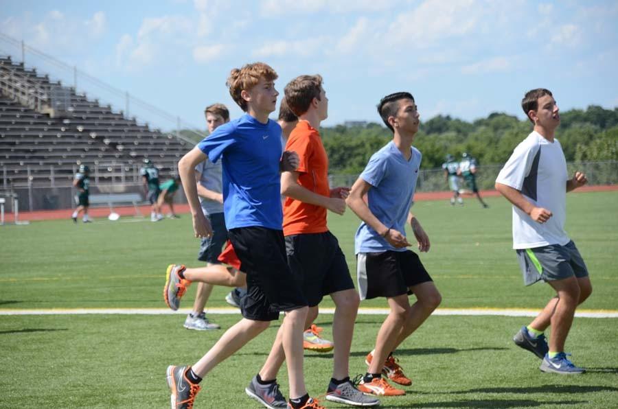 Boys cross country team starts off their practice doing cardio out on the field.