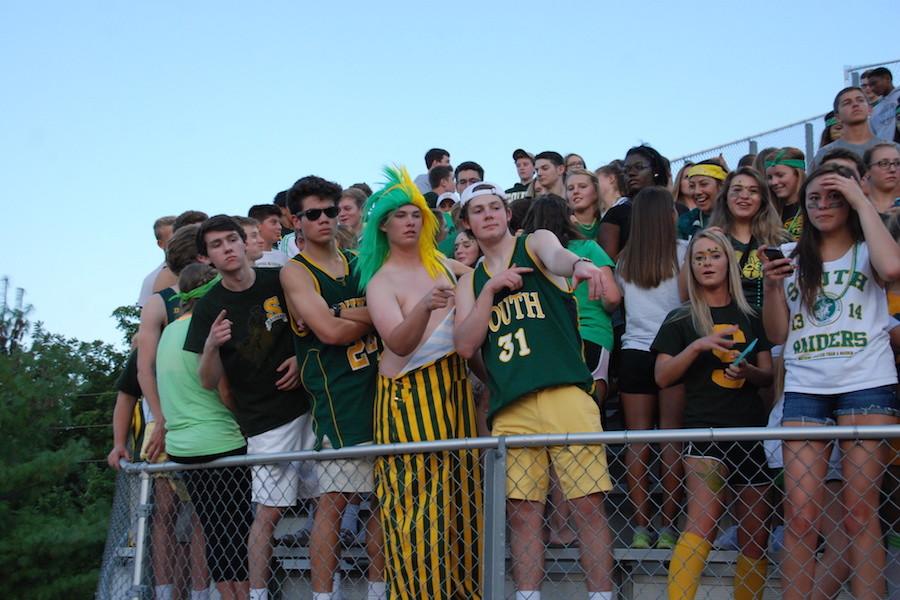 Crowd Control spectates the football game against SM North dressed according to the theme of Green & Gold.
