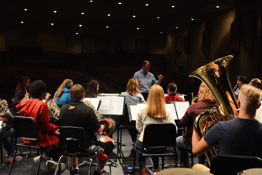 The+symphonic+band+practices+on+the+auditorium+stage+for+the+upcoming+concert.