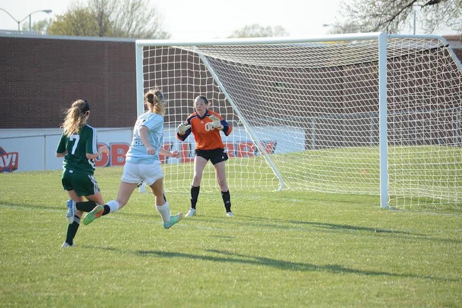 During the JV soccer game against SM East, Junior Morgan Cossairt tries to defend the ball.