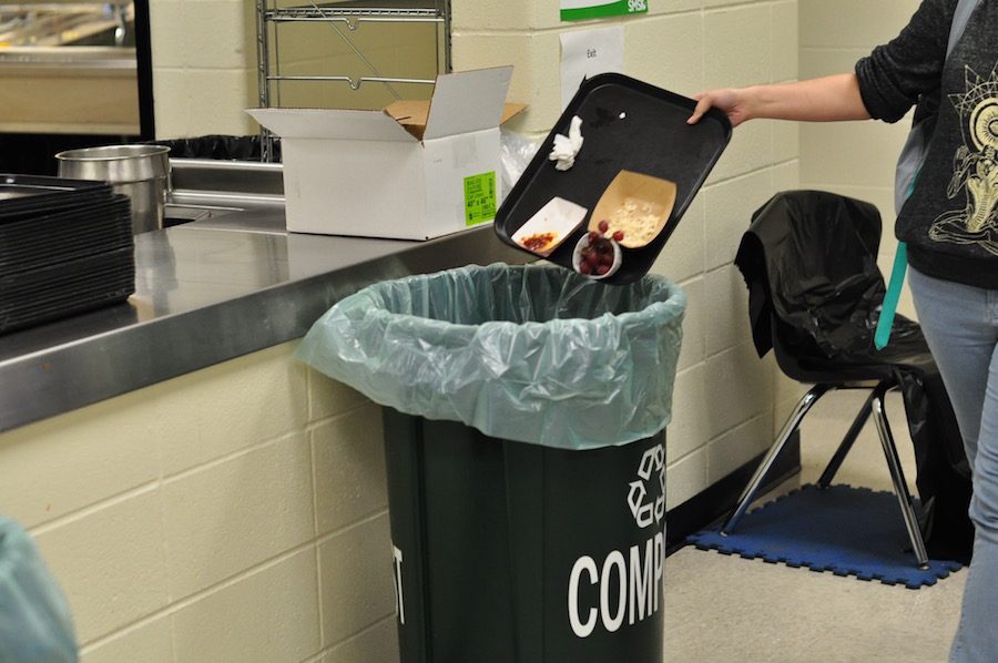 A student tosses his leftovers in the compost bin. South is recognized as the highest composting school in the district. photo by Kice Mansi