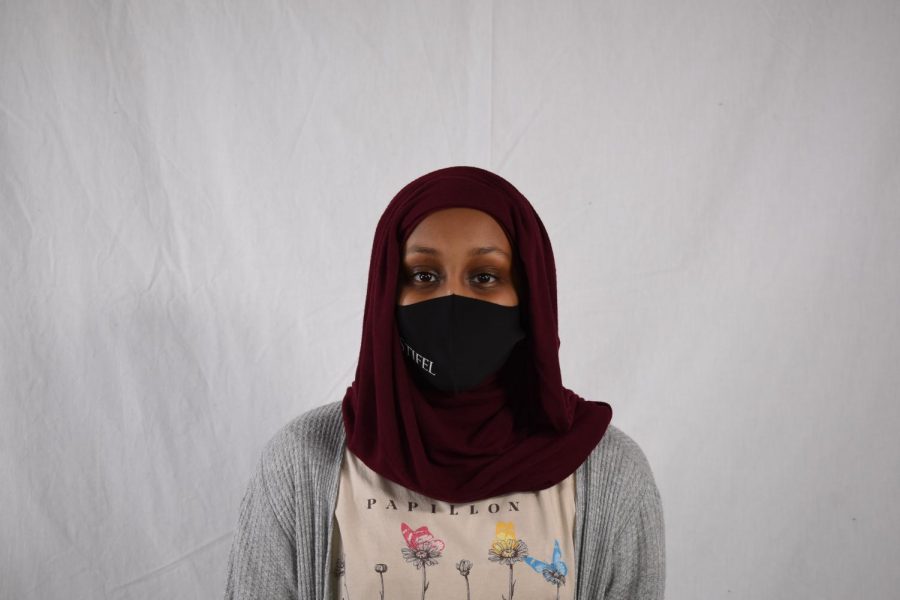 Reporter Noel Mohamed poses for her staff portrait in the photo studio.