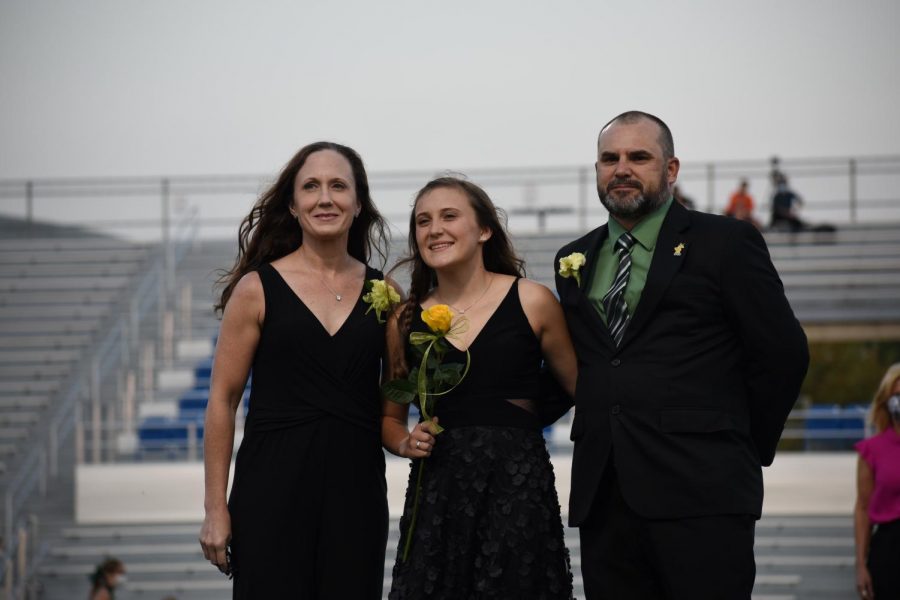 Senior Chloe Wannamaker being escorted by their family. 