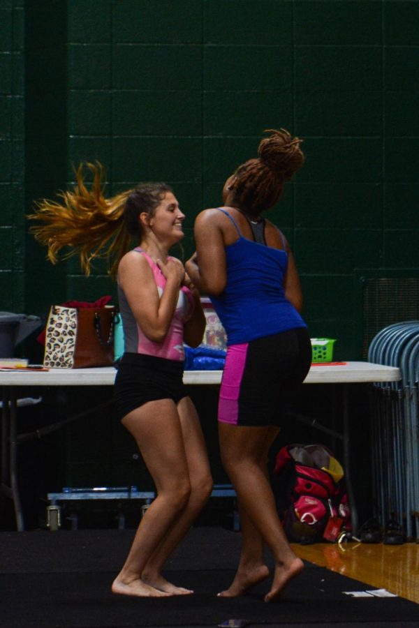 During practice, sophomores Rachel Brunk and Jada Johnson giggle together.