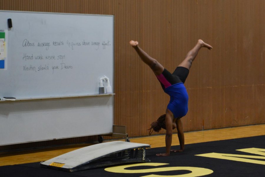 Coming off the springboard, sophomore Jada Johnson performs a cartwheel.