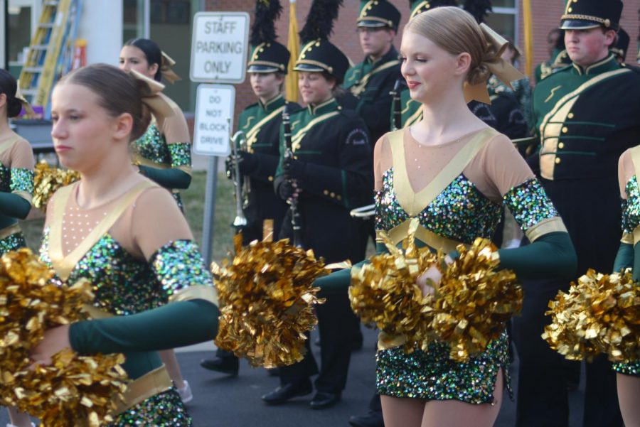 Smile on her face, sophomore Hailey Biswell marches with the band down to the stadium.