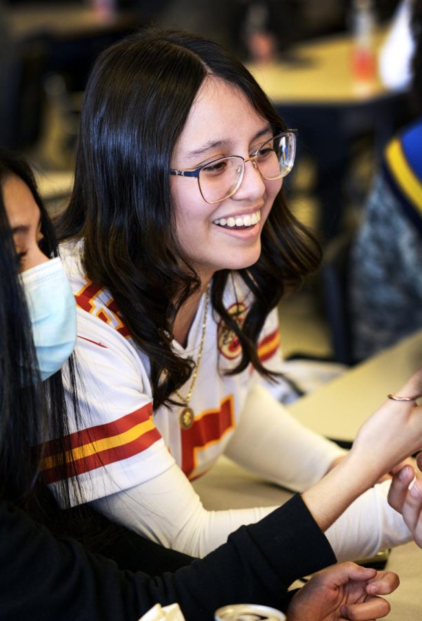 Laughing with friends, Monserrat Campos wears her Patrick Mahomes football jersey on jersey day during spirit week.