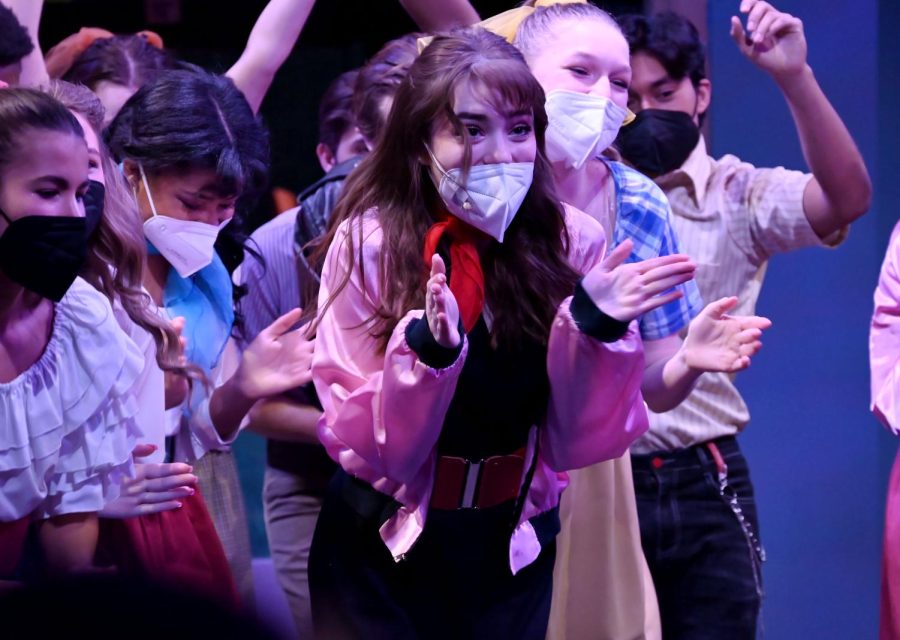 Enthusiastic as ever, senior Lily Cooper, performs the hand jive during a Grease the Musical dress rehearsal. Lily Cooper was casted to play Rizzo in Grease, which she is so excited for.