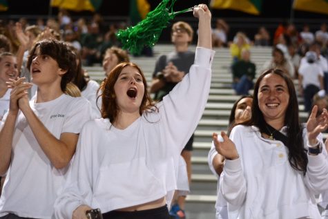 Seniors Sally Foley and Lauren Gunter cheers at the football game on October 21.