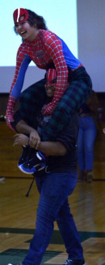 Antonio Rocha carries Mel Kelly on his shoulders at the beginning of the rock, paper, scissors tournament.