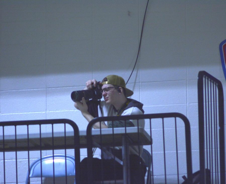 Brenden Pletke taking pictures of the crowd after the assembly.