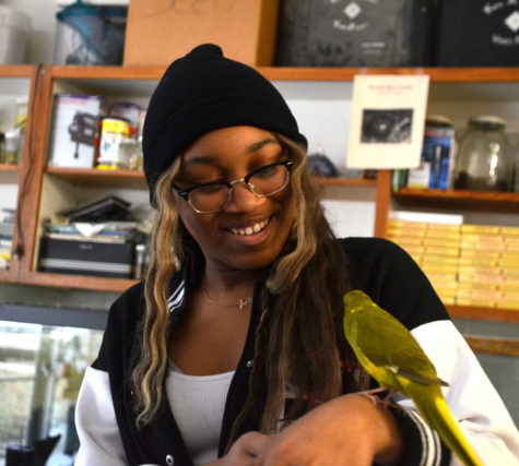 Junior Aniya Clark admires the Environmental Ed class bird during a class project
