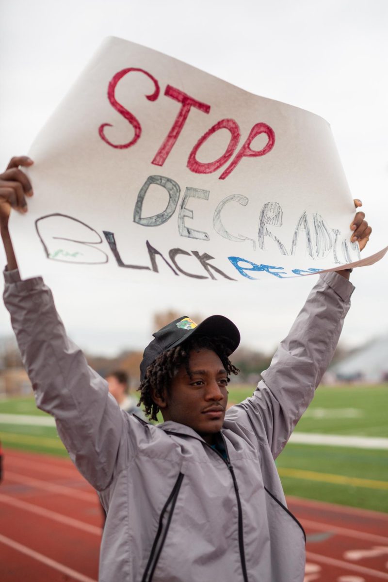 Sophomore Elijah Brown-Frazier holds a sign during the walkout Thursday.