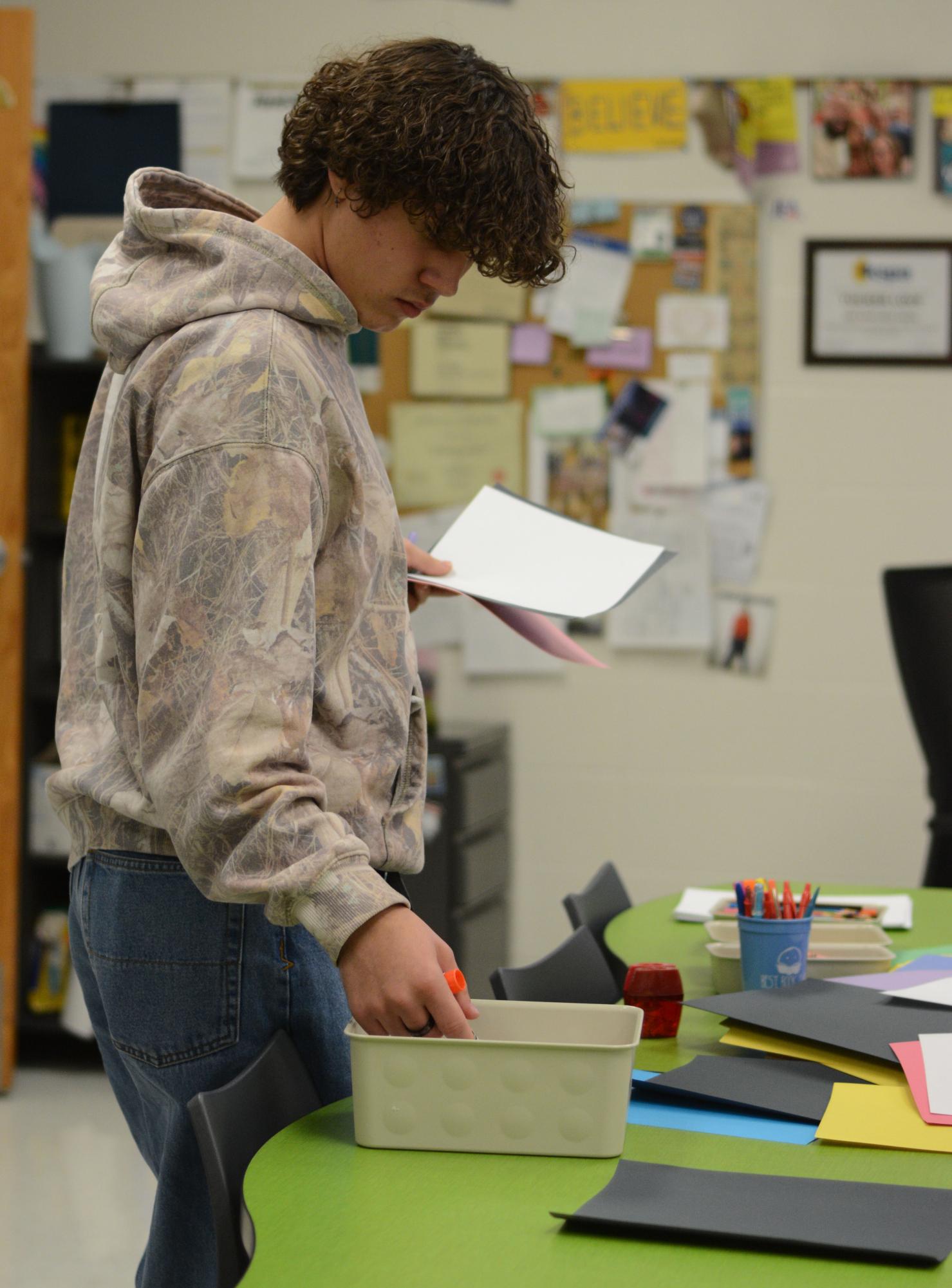 A week before Thanksgiving break, sophomore River Brown grabs a glue stick and paper to make a teacher appreciation card. "My favorite teacher is [Tucker] Love, he's a really kind person," said Brown.