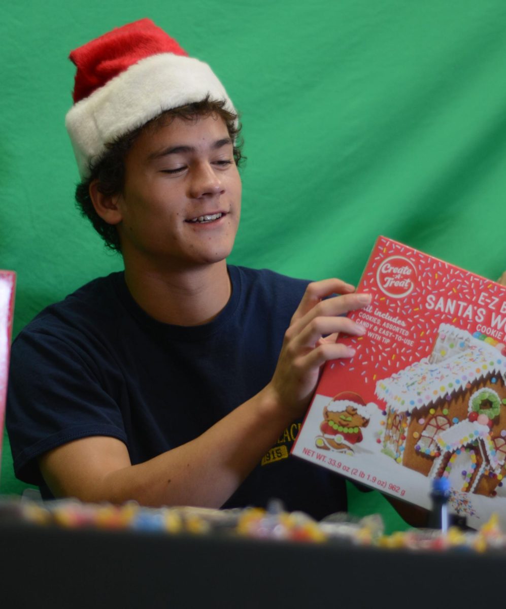 Unboxing the festive treat, junior Taegan Chambers prepares to decorate a tasty wintertime tradition with his classmates. 