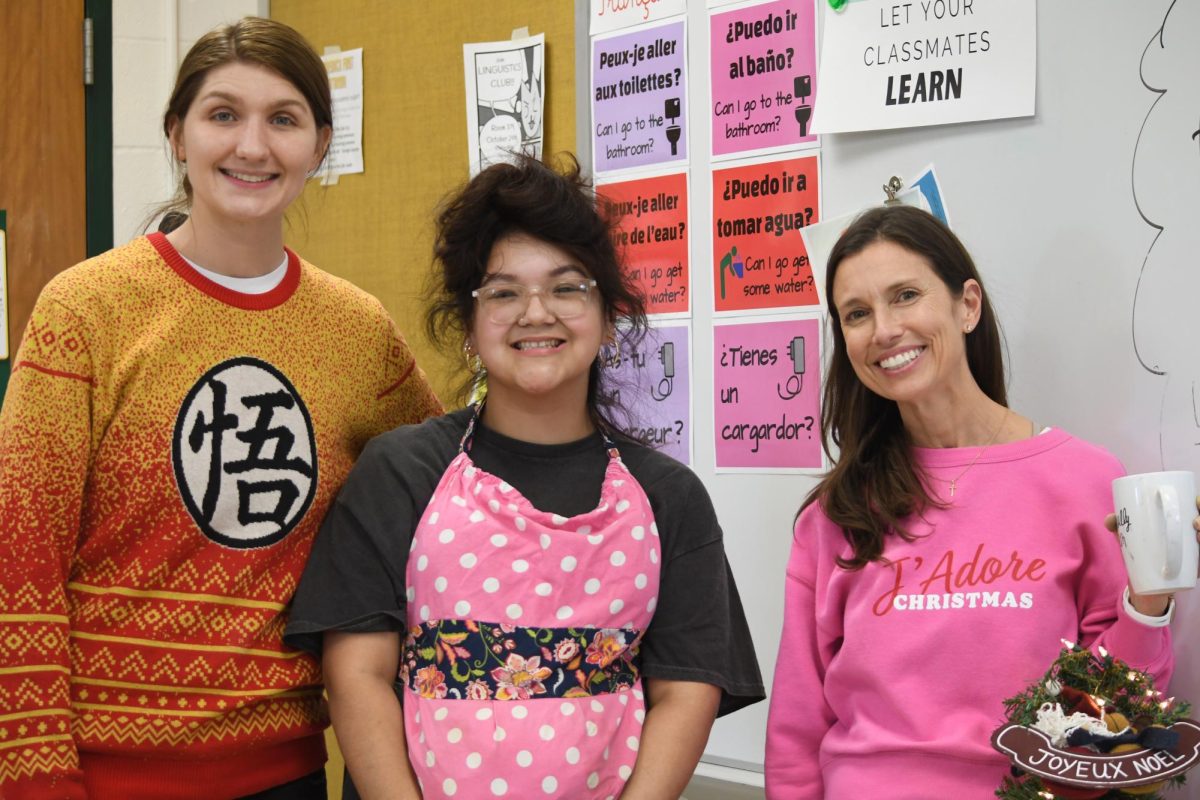 French teachers Brianna Ovalles and Erin Schneider pose for a picture with Senior Ayanna Alatorre at the December 11 French club meeting.