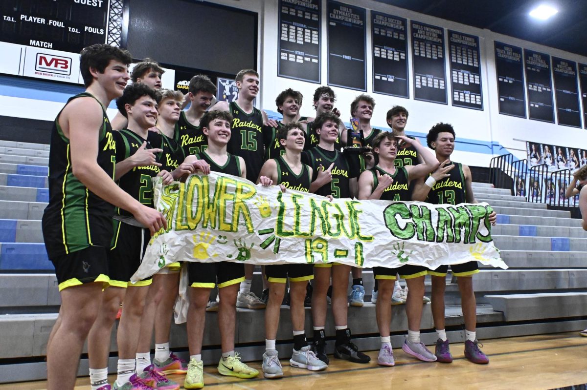 Raider Basketball team stands as a team after clinching Sunflower League title on  Feb. 28 at SM East