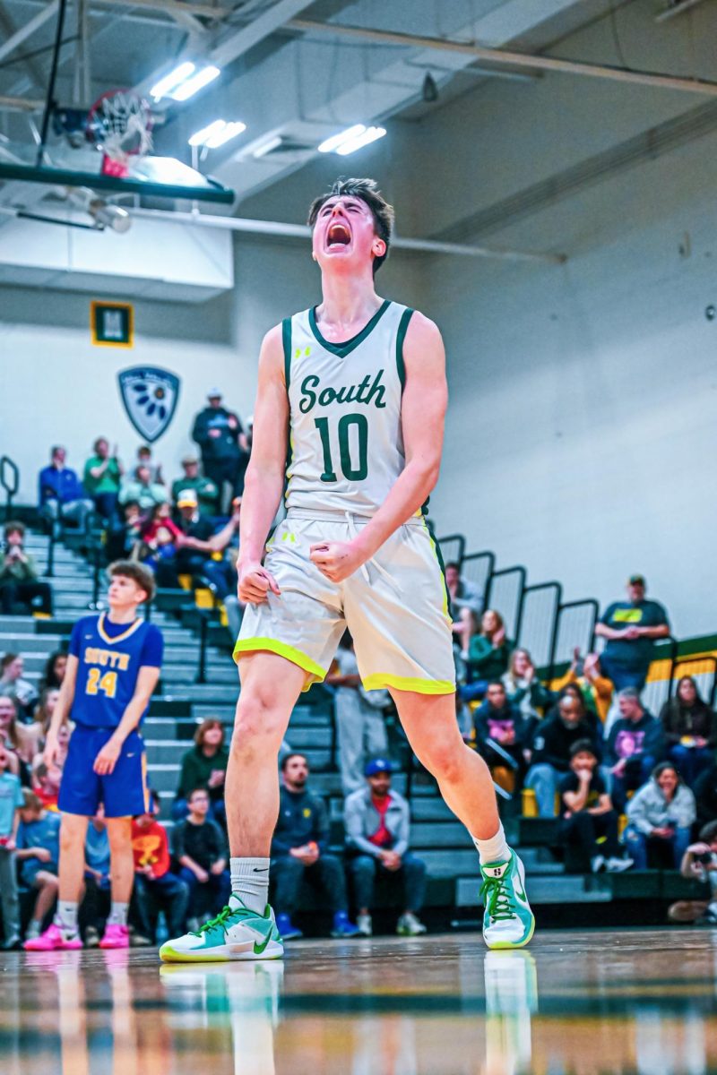 Junior Ben Allen gets amped up after  shooting and scoring an electrifying three pointer at the end of the third quarter.