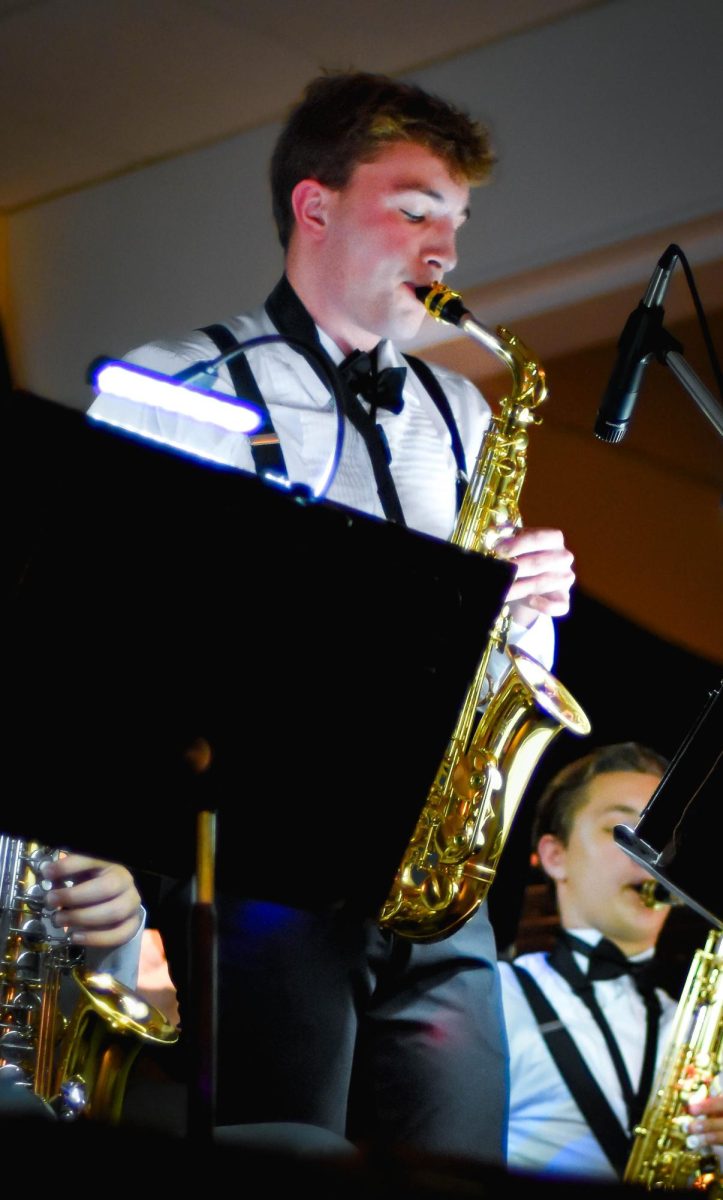 Performing at the evening of jazz on March 3, junior Charlie Eyler plays the alto saxophone. Eyler performed in front of a huge crowd, leading the entire band with his solo. 