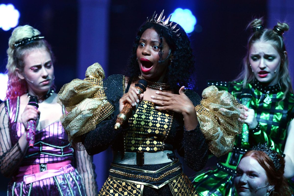 Lighting up the stage during their SIX the musical dress rehearsal on October 22, Seniors Nia Gosier and Millie Fickenscher tell the stories of their characters through singing about their lives. "Rehearsal was really great," Gosier said. "I think we got through the music really fast, just because it's a very popular musical, and we all really knew what we were doing. There was a lot of choreography that we got to learn, and it was just a whole lot of fun because everything was something new." Fickenscher said, "My favorite part of SIX was probably the bond the show gave all of us, and being able to perform with girls who have such a strong relationship with each other and being able to share our love for the art."