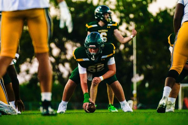 Preparing to snap the ball, junior Matt Parks lines up before south scores a touch down in the red zone during Souths homecoming game on Sept. 26 at South district stadium.
