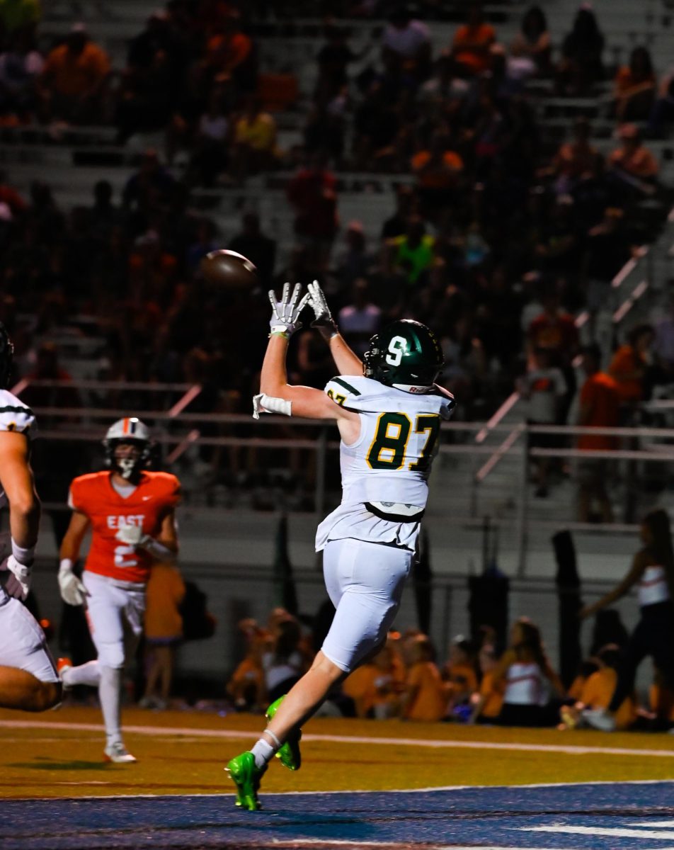 Senior Drake DeBaun catches a touchdown pass in the second quarter Friday, Oct. 3 at CBAC against Olathe East.