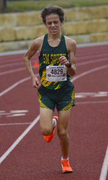 Fighting through the rain, sophmore runner Luke Jansen races through the final part of the course at Regionals on Oct. 25. The race helped Luke prepare for State at Rim Rock in the upcoming week. "Regionals was a very important race...I had to make sure I was one of the top 15 runners so that I could make it to state," Jansen said.