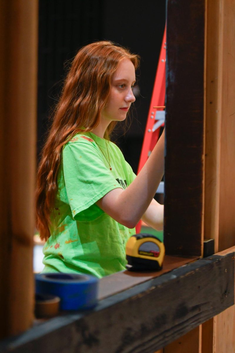 Backstage, Junior Kaia Bell works on the set of Mary Poppins. 