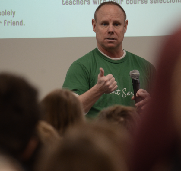 Counselor Chris Shelby talks to 8th graders about enrollment information and different elective opportunities available to them during the 8th grade showcase.