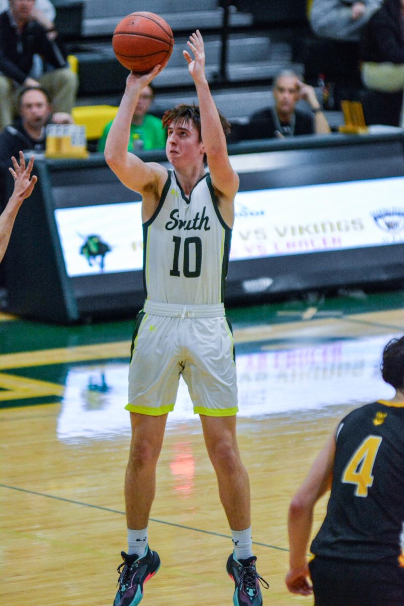 Senior Ben Allen shoots a three-pointer during a game against SM West on Friday, Jan. 9.