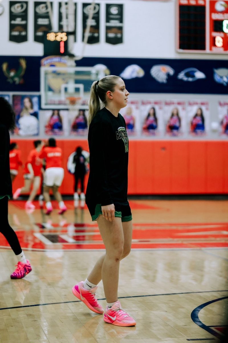 Senior Laila Berndt warms up before a game Tuesday night at Olathe North.